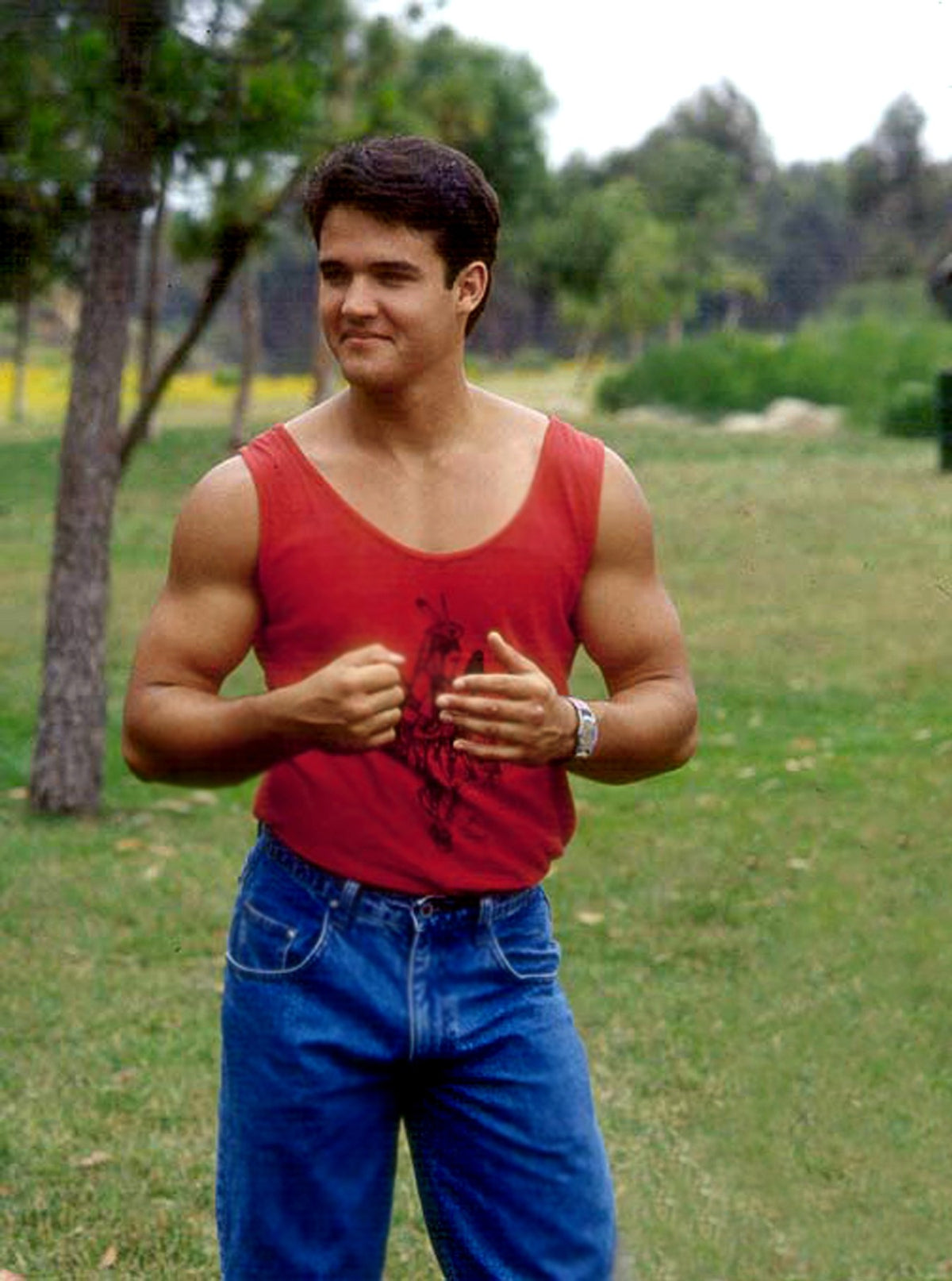 Austin St. John in a red tank top and jeans planning fight choreography with stunt team and DP Ilan Rosenberg, hand-signed by Austin St. John